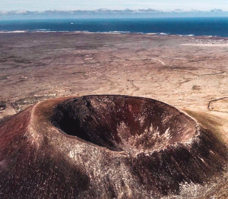 Caleta de Fuste/Corralejo: Guided E-Bike Tour & Crater Hike - Pickup and getting there: the gold bus and the red-shirt guide detail
